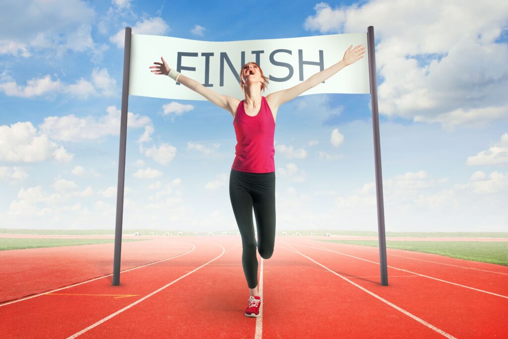 Woman crossing a finish line showcasing discharged from bankruptcy