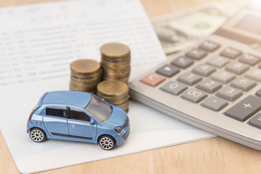 car with calculator and money showcasing vehicle finance and bankruptcy