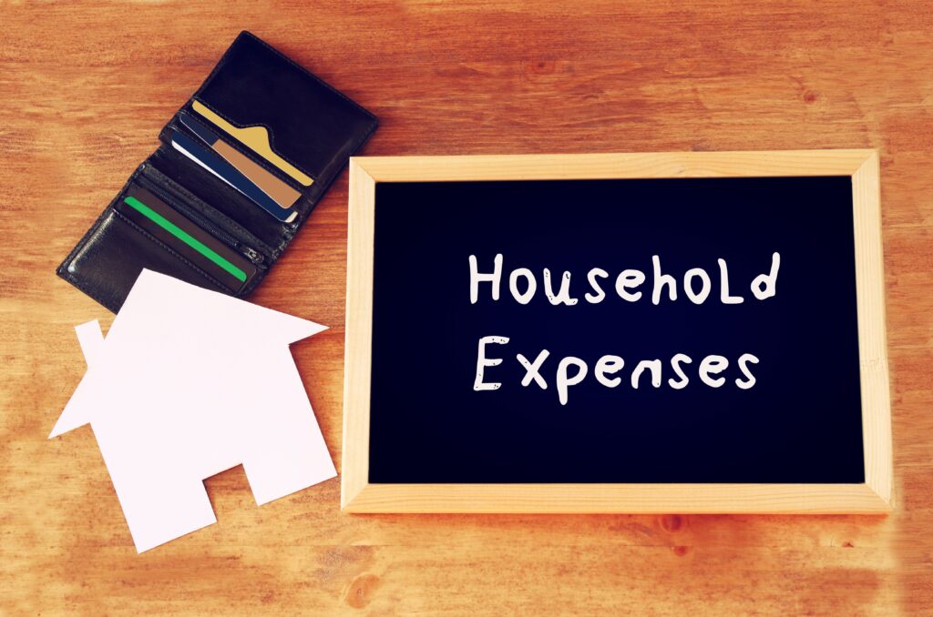 blackboard with the phrase household expenses showcasing bankruptcy income and expenses review
