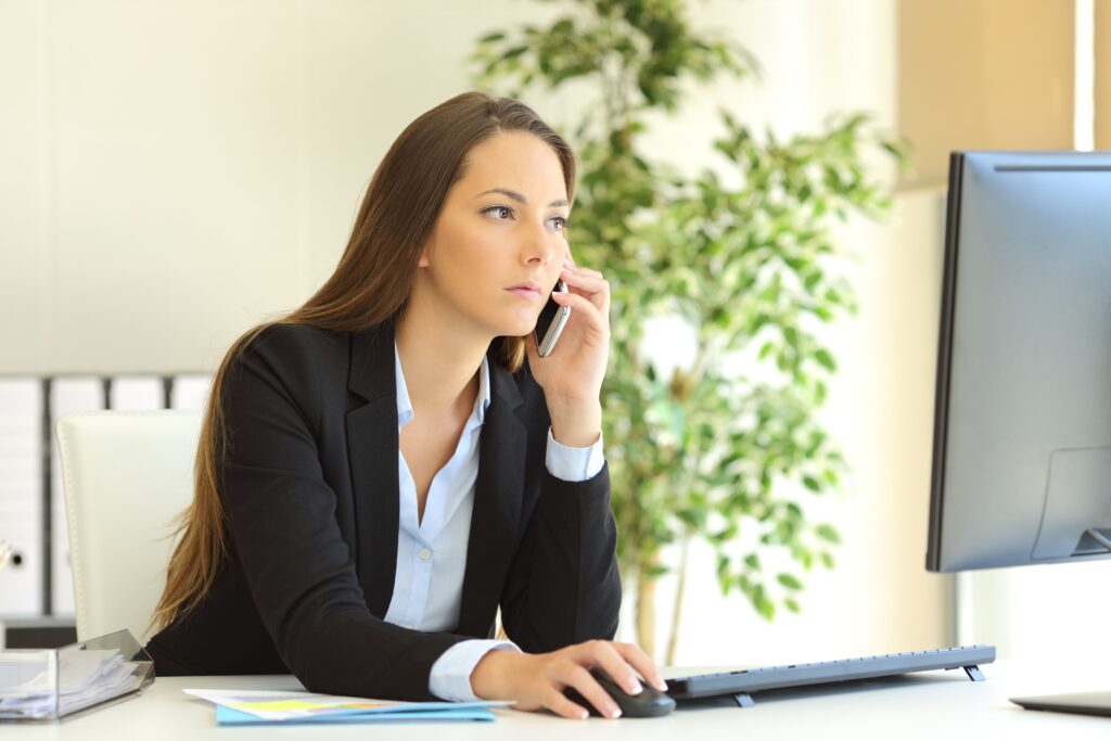 Businesswoman talking on the phone showcasing a telephone interview with the official receiver