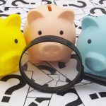 Three piggy banks with a magnifying glass looking at the Ultimate Bankruptcy Guide