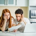 Young couple worried about debt showcasing joint debts and bankruptcy