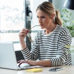 self employed woman reviewing her bounce back loan on laptop