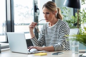 self employed woman reviewing her bounce back loan on laptop