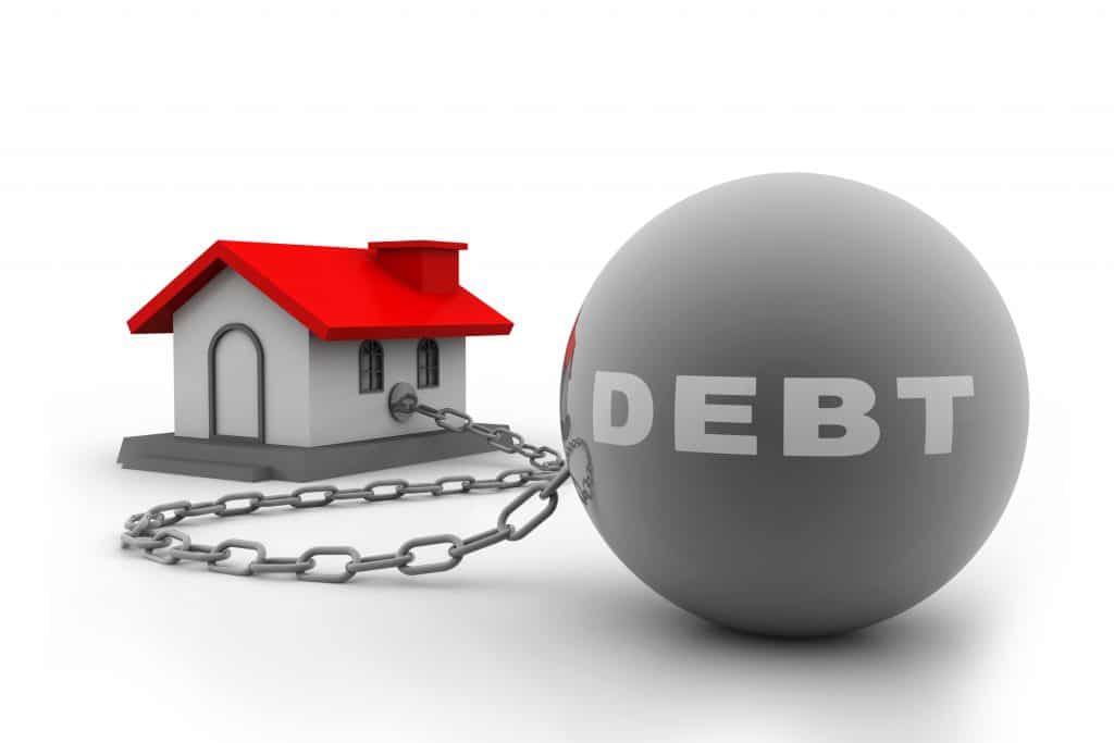 House tied to debt ball and chain showcasing mortgage shortfall and bankruptcy