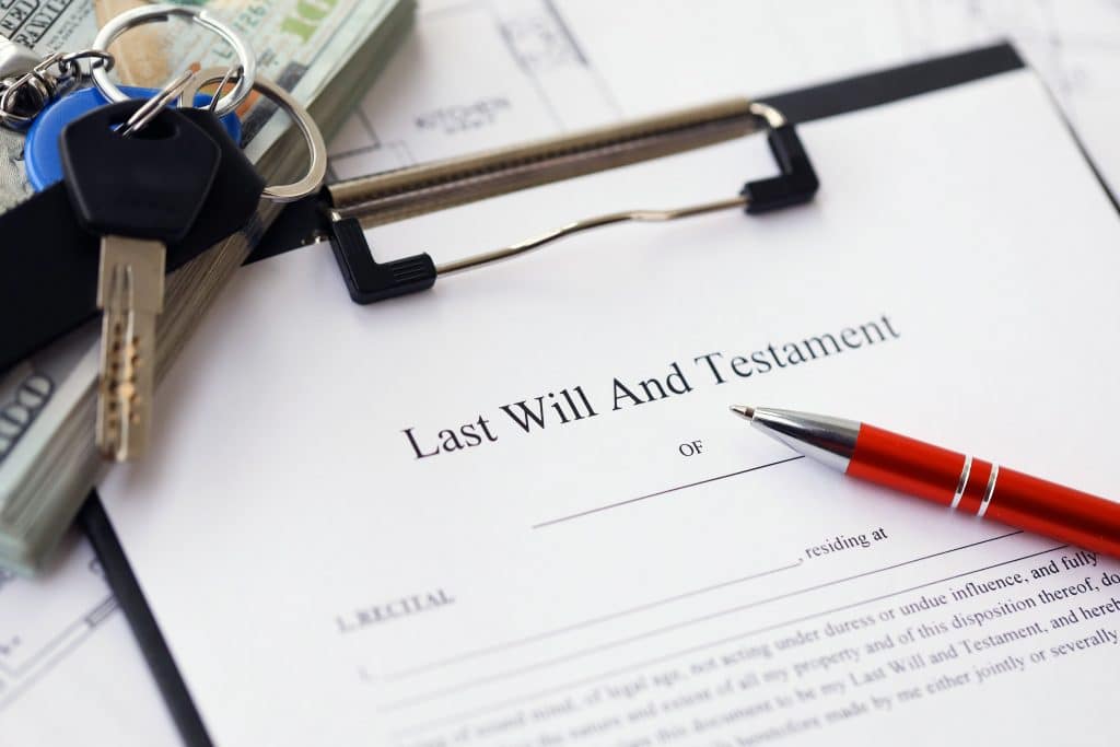 Pen and keys on Last will and testament showcasing what happens to inheritance if you are bankrupt