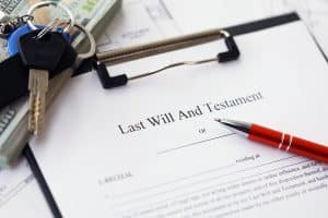 Pen and keys on Last will and testament showcasing what happens to inheritance if you are bankrupt