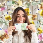 Happy woman under a rain of coins and banknotes showcasing what happens to a windfall in bankruptcy