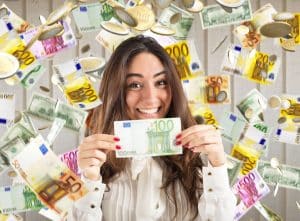 Happy woman under a rain of coins and banknotes showcasing what happens to a windfall in bankruptcy