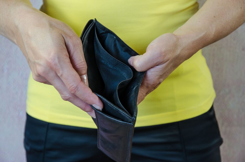 female hands showing empty wallet showcasing options if can't afford the bankruptcy fee