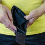 female hands showing empty wallet showcasing options if can't afford the bankruptcy fee