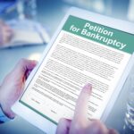 What Happens When You File For Bankruptcy bankrupty application on tablet showcasing what happens when you file for bankruptcy - uk