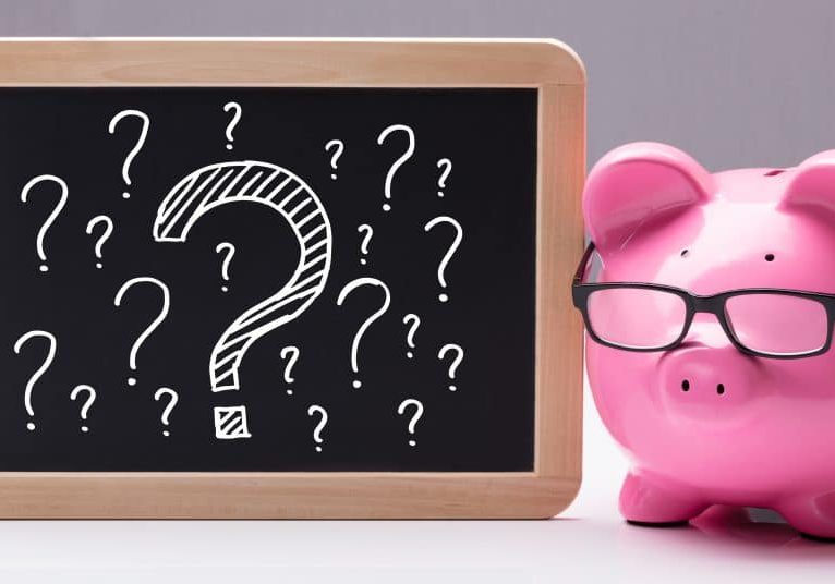 Piggy bank with question marks to represent questioning whether to switch from an IVA to Bankruptcy.